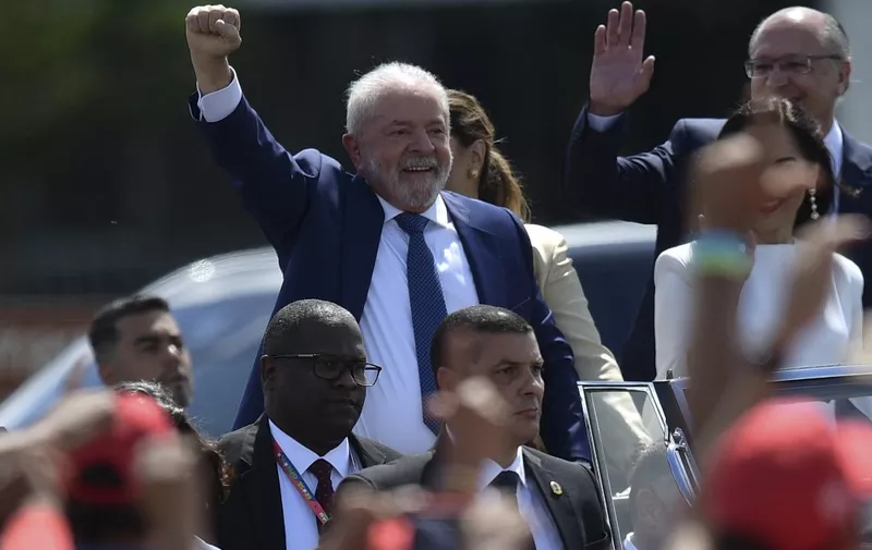 Brazil's President-elect Luiz Inacio Lula da Silva gestures at supporters on his way to the National Congress for his inauguration ceremony, in Brasilia, on January 1, 2023. - Lula da Silva, a 77-year-old leftist who already served as president of Brazil from 2003 to 2010, takes office for the third time with a grand inauguration in Brasilia. (Photo by CARL DE SOUZA / AFP)