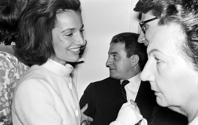 French fashion designer Yves Saint-Laurent (R)  speaks with princess Lee Radziwill (L) next to Pierre Berger (C) at the end of the presentation of his fashion show in Paris, in 1964. (Photo by AFP)