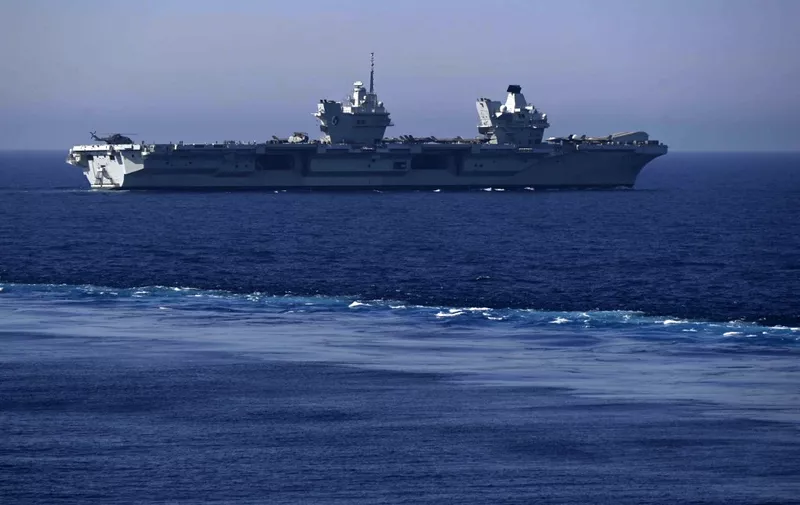 UK Royal Navy's aircraft carrier HMS Queen Elizabeth sails during the Navy exercise "Gallic strike" off the coast of Toulon, south-eastern France on June 3, 2021. - This unprecedented joint maneuver called "Gallic Strike", which has mobilized since two days 14 warships and 56 combat aircraft off the coast of Toulon, aims in particular to train to conduct strikes from the sea, and to operate jointly the tricolor Rafale Marine fighter planes, catapulted, and the British F-35s which take off vertically or using a springboard. (Photo by Christophe SIMON / AFP)