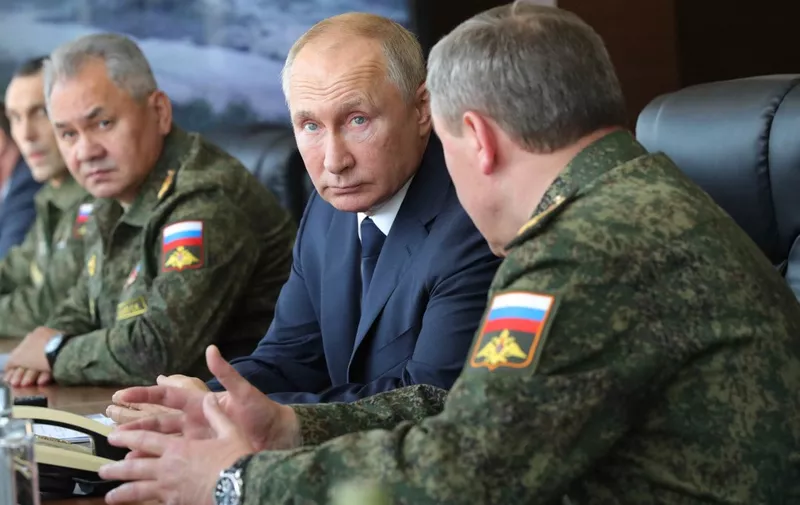 Russian President Vladimir Putin, accompanied by Defence Minister Sergei Shoigu, oversees the "Caucasus-2020" military exercises at the Kapustin Yar range near the city of Astrakhan on September 25, 2020. (Photo by Mikhail KLIMENTYEV / SPUTNIK / AFP)