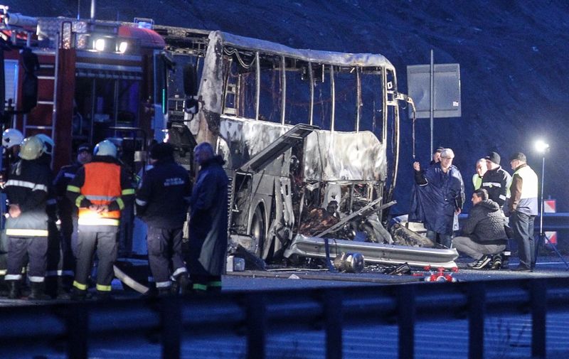 Officials work at the site of a bus accident, in which at least 45 people were killed, on a highway near the village of Bosnek, south of Sofia, on November 23, 2021. (Photo by Dimitar KYOSEMARLIEV / AFP)
