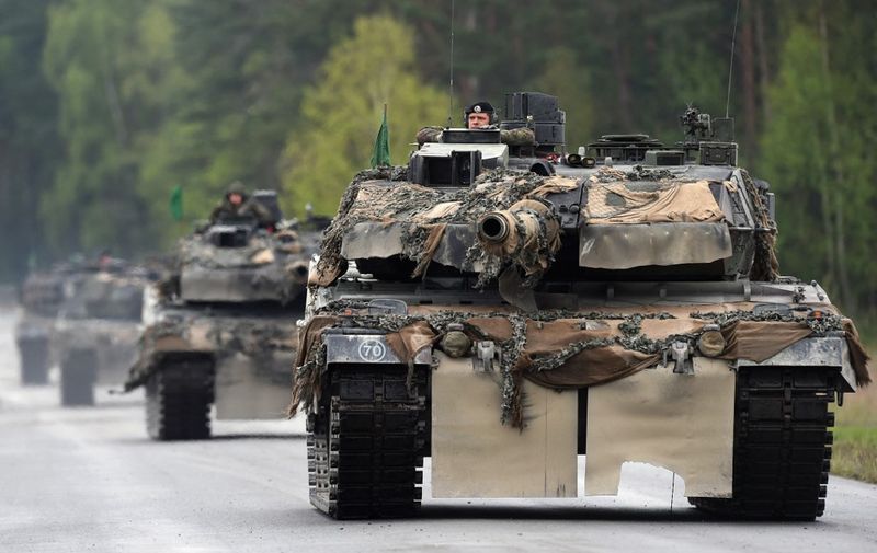 (FILES) This file photo taken on May 12, 2017 shows German soldiers on Lepard tanks arriving for a friendship shooting of several nations during the exercise 'Strong Europe Tank Challenge 2017' at the military training area in Grafenwoehr, near Eschenbach, southern Germany. - Germany on January 25, 2023 approved the delivery of Leopard 2 tanks to Ukraine, after weeks of pressure from Kyiv and many allies. Berlin will provide a company of 14 Leopard 2 A6 tanks from the Bundeswehr stocks and is also granting approval for other European countries to send tanks from their own stocks to Ukraine, a government spokesman said in a statement. (Photo by Christof STACHE / AFP)