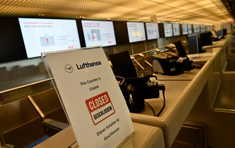 (FILES) This file photo taken on June 11, 2020 shows a closed check-in desk of German airline Lufthansa at Berlins Tegel Airport. - German national carrier Lufthansa is braced for further travel upheaval as the country's powerful Verdi union called on ground crew to strike on July 27, 2022 in a row over higher wages. The stoppage from 0145 GMT on July 27 until 0400 GMT on July 28 will cause "major flight cancellations and delays", Verdi warned on Monday, July 25. The walkout at one of Europe's largest airlines adds to a troubled summer season at airports across the continent as eased coronavirus restrictions have boosted tourism demand, but chronic staff shortages have left passengers grappling with flight disruptions, long queues and lost luggage. (Photo by Tobias SCHWARZ / AFP)