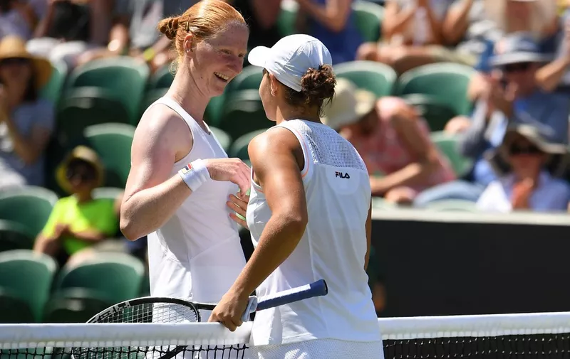 Belgium's Alison van Uytvanck (L) congratulates Australia's Ashleigh Barty fater their women's singles second round match on the fourth day of the 2019 Wimbledon Championships at The All England Lawn Tennis Club in Wimbledon, southwest London, on July 4, 2019. (Photo by Ben STANSALL / AFP) / RESTRICTED TO EDITORIAL USE