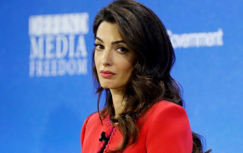 (FILES) In this file photo taken on July 10, 2019, Lebanese-British human-rights lawyer Amal Clooney takes part in a panel discussion at the Global Conference for Media Freedom in London. - Clooney quit as Britain's special envoy on media freedom in protest at the Government's  decision to reverse the agreement on leaving the Union European. (Photo by Tolga AKMEN / AFP)