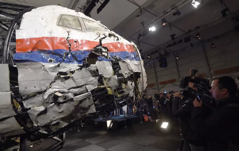 The wrecked cockipt of the Malaysia Airlines flight  MH17 is presented to the press during a presentation of the final report on the cause of the its crash at the Gilze Rijen airbase October 13, 2015. Air crash investigators have concluded that Malaysia Airlines flight MH17 was shot down by a missile fired from rebel-held eastern Ukraine, sources close to the inquiry said today, triggering a swift Russian denial. The findings are likely to exacerbate the tensions between Russia and the West, as ties have strained over the Ukraine conflict and Moscow's entry into the Syrian war.   AFP PHOTO / EMMANUEL DUNAND