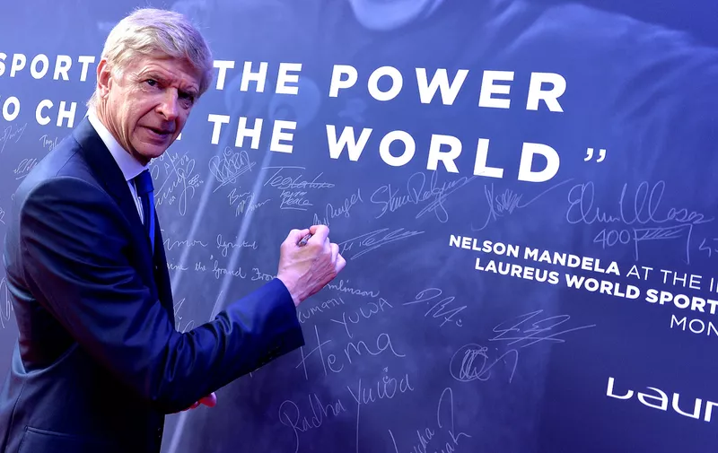 MONACO, MONACO - FEBRUARY 18:  Arsene Wenger signs the Nelson Mandela wall during the 2019 Laureus World Sports Awards on February 18, 2019 in Monaco, Monaco. (Photo by Christian Alminana/Getty Images for Laureus)