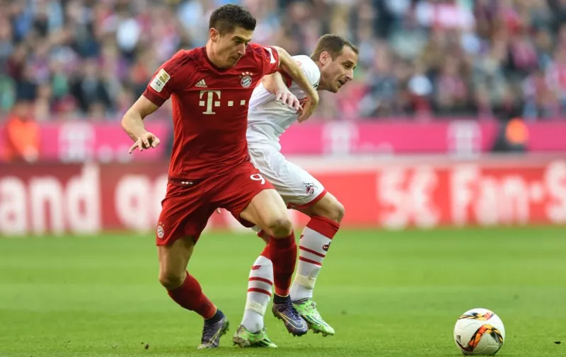 Bayern Munich's Polish striker Robert Lewandowski (L) and Cologne's midfielder Matthias Lehmann vies for the ball with during the German first division football Bundesliga match between FC Bayern Munich and FC Cologne on October 24, 2015 in Munich, southern Germany. AFP PHOTO / CHRISTOF STACHE

RESTRICTIONS: DURING MATCH TIME: DFL RULES TO LIMIT THE ONLINE USAGE TO 15 PICTURES PER MATCH AND FORBID IMAGE SEQUENCES TO SIMULATE VIDEO. 
==RESTRICTED TO EDITORIAL USE ==
FOR FURTHER QUERIES PLEASE CONTACT THE DFL DIRECTLY AT + 49 69 650050.