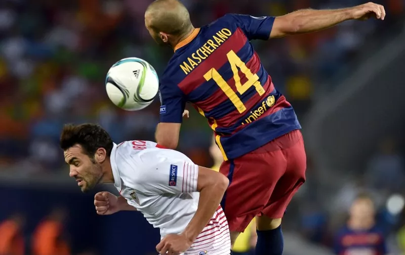 Barcelona's Argentinian defender Javier Mascherano (R) vies with Sevilla's midfielder Vicente Iborra during the UEFA Super Cup final football match between FC Barcelona and Sevilla FC on August 11, 2015 at the Boris Paichadze Dinamo Arena in Tbilisi. AFP PHOTO / KIRILL KUDRYAVTSEV