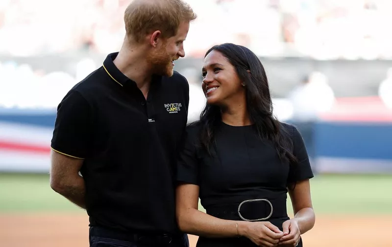 Britain's Prince Harry, Duke of Sussex and Britain's Meghan, Duchess of Sussex arrive on the field prior to the start of the first of a two-game series between  the New York Yankees and the Boston Red Sox at London Stadium in Queen Elizabeth Olympic Park, east London on June 29, 2019. - As Major League Baseball prepares to make history in London, New York Yankees manager Aaron Boone and Boston Red Sox coach Alex Cora are united in their desire to make the ground-breaking trip memorable on and off the field. (Photo by PETER NICHOLLS / POOL / AFP)
