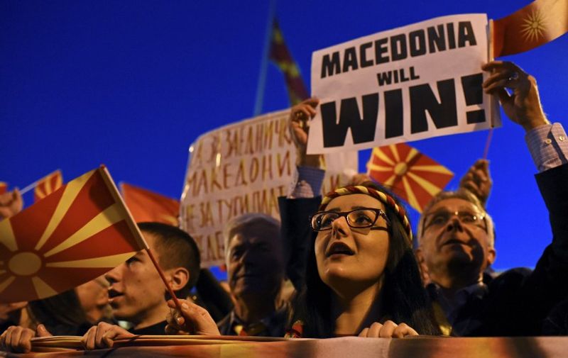 Supporters of the Civil Initiative "For United Macedonia" wave flags and carry placards during a protest while European Commissioner for Enlargement Negotiations Johannes Hahn (not pictured) is meeting political leaders on March 21, 2017 in Skopje.
At least 50,000 Macedonians protested March 21 in Skopje against a coalition government between Social Democrats and ethnic Albanians, which they perceive as a threat to the country's national unity. The protest took place while European Union Enlargement Commissioner Johannes Hahn visited the Macedonian capital.
 / AFP PHOTO / Tomislav GEORGIEV