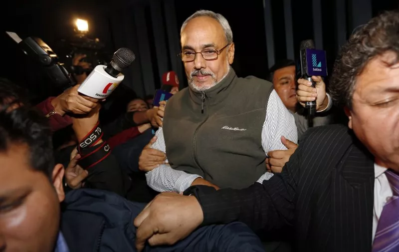 Former President of the Peruvian Football Association (FPF), Manuel Burga (C), is transported from a coroners physical examination office to a police judiciary facility following his arrest in Lima, Peru, on the eve of December 5, 2015, after his name appeared on a list of  FIFA officers accused of finance embezzlement.
The former president of the Peruvian Football Federation, indicted in the FIFA corruption scandal, was arrested late on December 5 on an international arrest warrant, and protested his innocence as he was taken away.
 / AFP / LUKA GONZALES