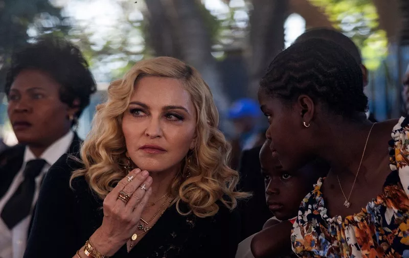 (FILES) US pop star Madonna looks one inside the Mercy James Centre during the opening ceremony at Queen Elizabeth Hospital in Malawi's Commercial City of Blantyre on July 11, 2017. Madonna is recovering after falling ill with a "serious bacterial infection" that landed her in an intensive care unit for several days, her manager Guy Oseary said in a statement posted to social media on June 28.
"Her health is improving, however she is still under medical care," he said. "A full recovery is expected."
Oseary said the pop icon's "Celebrations" tour, due to start July 15 in Vancouver, was postponed until further notice. (Photo by Amos Gumulira / AFP)
