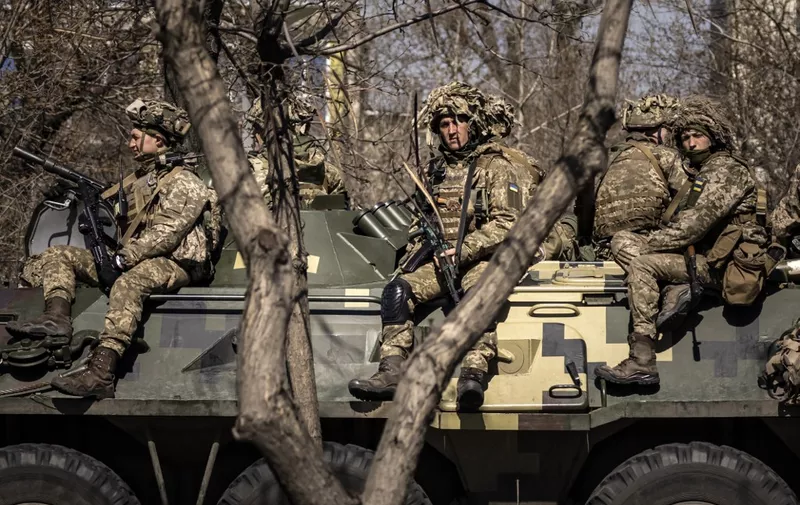 Ukrainian soldiers sit on a armoured military vehicule in the city of Severodonetsk, Donbas region, on April 7, 2022, amid Russia's military invasion launched on Ukraine. - Six weeks after invading its neighbour, Russia's troops have withdrawn from Kyiv and Ukraine's north and are focusing on the country's southeast, where desperate attempts are under way to evacuate civilians. (Photo by FADEL SENNA / AFP)