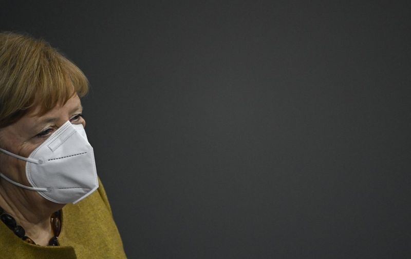 German Chancellor Angela Merkel wears a face mask after addressing the Bundestag (lower house of parliament) on the government's measures to fight the coronavirus pandemic, on February 11, 2021 in Berlin. (Photo by Tobias SCHWARZ / AFP)