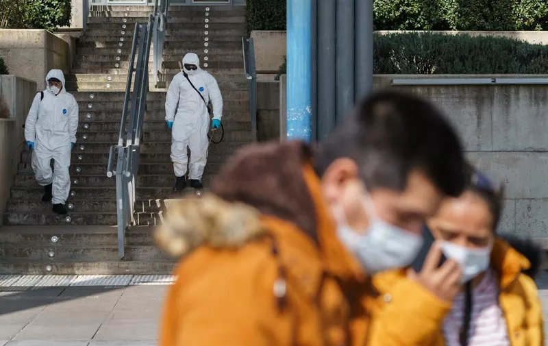 Firefighters of the Burgos City Council disinfect the entrance to the Burgos Hospital in northern Spain on March 23, 2020 amid a national lockdown to fight the spread of the COVID-19 coronavirus. - The coronavirus death toll in Spain surged to 2,182 after 462 people died within 24 hours, the health ministry said. (Photo by CESAR MANSO / AFP)