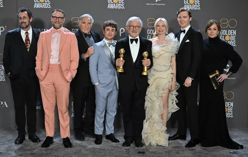 US director Steven Spielberg (C) poses with the awards for Best Director - Motion Picture and Best Picture - Drama for "The Fabelmans" alongside US author Tony Kushner (L), Canadian-US actor Seth Rogen (2nd L), US actor Judd Hirsch (3rd L), Canadian-US actor Gabriel LaBelle (4th L), US actress Michelle Williams (3rd R), US actor Paul Dano (2nd R) and US producer Kristie Macosko Krieger (R) in the press room during the 80th annual Golden Globe Awards at The Beverly Hilton hotel in Beverly Hills, California, on January 10, 2023. (Photo by )
