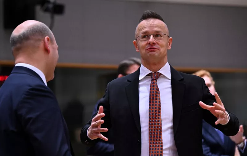 Polish Foreign Affairs Minister Szymon Szynkowski vel Sek (L) talks with Hungary Foreign Minister Peter Szijjarto during a General Affairs Council (GAG) meeting at the EU headquarters in Brussels on December 12, 2023. (Photo by JOHN THYS / AFP)