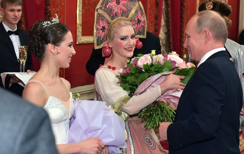 President of Russia Vladimir Putin (L) congratulates ballet dancers who took part in The Nutcracker directed by Yury Grigorovich as part of the 2019 New Year gala event held at the State Academic Bolshoi Theatre in Moscow on December 27, 2018. - Members of the Russian government, representatives of the Federation Council, State Duma, federal executive and juridical bodies, regional bodies, scientists, cultural figures, artists, athletes, military personnel, religious heads, leaders of political parties and heads of the largest enterprises and public organizations were invited. (Photo by Alexei Druzhinin / Sputnik / AFP) / The erroneous mention appearing in the metadata of this photo by Alexei Druzhinin has been modified in AFP systems in the following manner: [December 27] instead of [December 28]. Please immediately remove the erroneous mention from all your online services and delete it from your servers. If you have been authorized by AFP to distribute it to third parties, please ensure that the same actions are carried out by them. Failure to promptly comply with these instructions will entail liability on your part for any continued or post notification usage. Therefore we thank you very much for all your attention and prompt action. We are sorry for the inconvenience this notification may cause and remain at your disposal for any further information you may require.