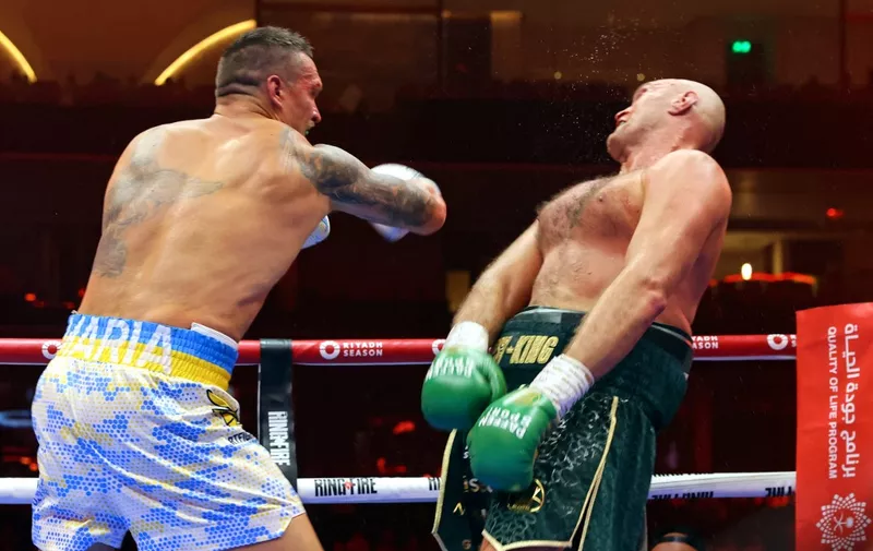 Ukraine's Oleksandr Usyk (L) fights against Britain's Tyson Fury during a heavyweight boxing world championship fight at Kingdom Arena in Riyadh, Saudi Arabia on May 19, 2024. Oleksandr Usyk beat Tyson Fury by split decision to win the world's first undisputed heavyweight championship in 25 years on May 19, 2024, an unprecedented feat in boxing's four-belt era. (Photo by Fayez NURELDINE / AFP)