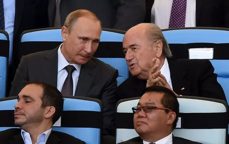 Russian President Vladimir Putin (L) and FIFA President Joseph Blatter attend the 2014 FIFA World Cup final football match between Germany and Argentina at the Maracana Stadium in Rio de Janeiro, Brazil, on July 13, 2014. AFP PHOTO / PEDRO UGARTE
