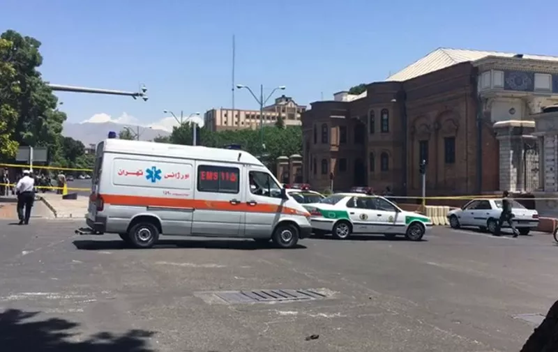 An image grab taken from AFPTV shows ambulances and police vehicles arriving at the scene outside Iranian parliament in the capital Tehran on June 7, 2017 during an attack on the complex.
Gunmen and suicide bombers carried out coordinated attacks on Iran's parliament and the tomb of revolutionary founder Ruhollah Khomeini on June 7, 2017, state media reported, killing at least three people. / AFP PHOTO / AFPTV / Majid SOURATI / The erroneous mention[s] appearing in the metadata of this photo by STRINGER has been modified in AFP systems in the following manner: [shows ambulances and police vehicles arriving at the scene outside Iranian parliament in the capital Tehran on June 7, 2017 during an attack on the complex] instead of [shows ambulances and police vehicles arriving at the scene outside the mausoleum of Ayatollah Ruhollah Khomeini, the late founder of the Islamic republic, in Tehran's southern suburb of Mossala, during an attack on the complex on June 7, 2017]. Please immediately remove the erroneous mention[s] from all your online services and delete it (them) from your servers. If you have been authorized by AFP to distribute it (them) to third parties, please ensure that the same actions are carried out by them. Failure to promptly comply with these instructions will entail liability on your part for any continued or post notification usage. Therefore we thank you very much for all your attention and prompt action. We are sorry for the inconvenience this notification may cause and remain at your disposal for any further information you may require.