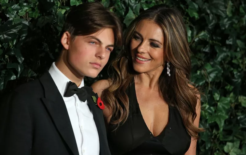 British actress Elizabeth Hurley (R) and her son Damian pose on the red carpet as they attend the 62nd London Evening Standard Theatre Awards 2016 in London on November 13, 2016. - The Evening Standard Theatre Awards were established in 1955 to recognise outstanding achievement in London based Theatre, from actors to playwrights, designers to directors. (Photo by DANIEL LEAL-OLIVAS / AFP)