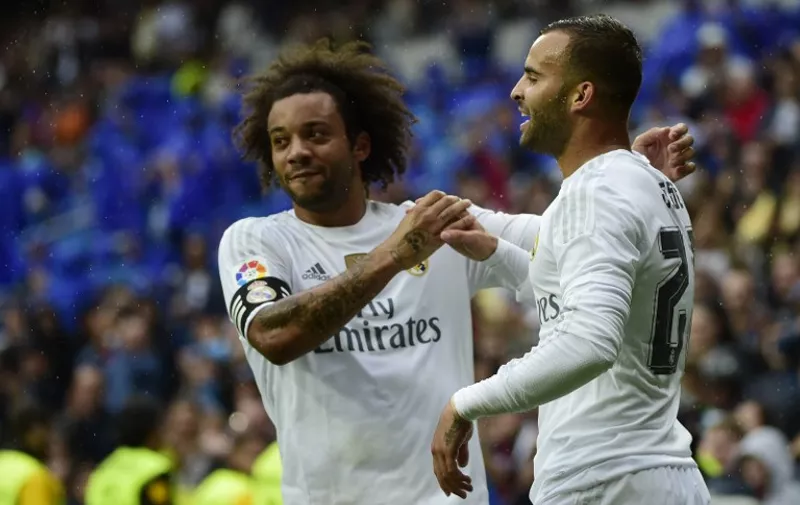 Real Madrid's forward Jese Rodriguez (R) celebrates a goal with Real Madrid's Brazilian defender Marcelo during the Spanish league football match Real Madrid CF vs Levante UD at the Santiago Bernabeu stadium in Madrid on October 17, 2015. AFP PHOTO/ PIERRE-PHILIPPE MARCOU