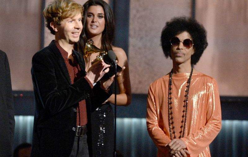 LOS ANGELES, CA - FEBRUARY 08: Musician Beck (L) accepts the Album of the Year award for "Morning Phase" from musician Prince onstage during The 57th Annual GRAMMY Awards at the at the STAPLES Center on February 8, 2015 in Los Angeles, California.   Kevork Djansezian/Getty Images/AFP