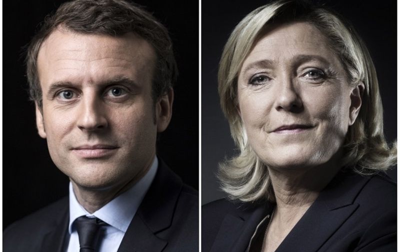 A combination of picture made on April 23, 2017 shows French presidential election candidate for the En Marche ! movement Emmanuel Macron and French presidential election candidate for the far-right Front National (FN) party Marine Le Pen posing in Paris.
Emmanuel Macron and Marine Le Pen are shown ahead in the French presidential race, in a projection announced on April 23, 2017.  / AFP PHOTO / Joël SAGET AND Eric Feferberg
