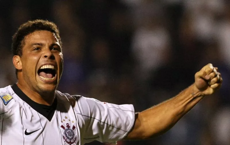 (FILE) Brazilian striker of Corinthians Ronaldo celebrates his second goal against Atletico Paranaense, during their 2009 Brazil's Cup football match, at Pacaembu Stadium, in Sao Paulo, Brazil, on May 6, 2009. Double World Cup winner Ronaldo, who is now playing for Sao Paulo's Corinthians, said he would retire from professional football at the end of next year. The three-times world footballer of the year aged 33 told a media conference he would continue to represent Corinthians afterwards, but only as an "ambassador."AFP PHOTO/Mauricio LIMA