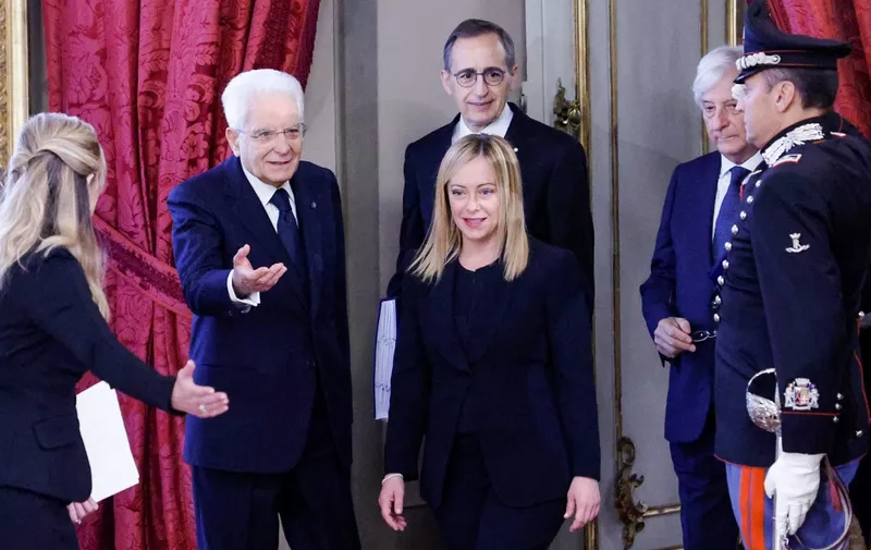 Italian President Sergio Mattarella (2nd L) welcomes new Prime Minister Giorgia Meloni (C) as she arrives for the swearing-in ceremony of the new Italian Government at the Quirinal Palace in Rome on October 22, 2022. (Photo by FABIO FRUSTACI / ANSA / AFP) / Italy OUT