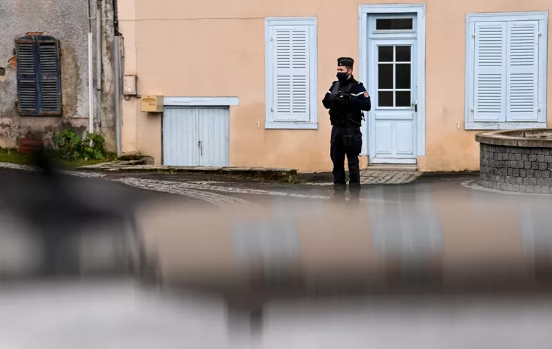 A French Gendarme stands guard in a street Saint-Just, central France on December 23, 2020, after three gendarmes were killed and a fourth wounded by a gunman they confronted in response to a domestic violence call. - The suspect, a 48-year-old man known to authorities for child custody disputes, was "discovered dead" several hours after fleeing the home in an isolated hamlet near Saint-Just, a village south of the city of Clermont-Ferrand, Interior Minister Gerald Darmanin said in a tweet. (Photo by OLIVIER CHASSIGNOLE / AFP)