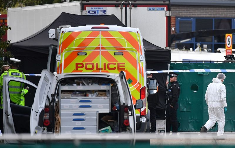 British Police officers in forsensic suits work near a lorry, believed to have originated from Bulgaria, and found to be containing 39 dead bodies, as they work inside a police cordon at Waterglade Industrial Park in Grays, east of London, on October 23, 2019. - Britain launched a major murder investigation after 39 bodies were found Wednesday in a truck from Bulgaria, as police tried to establish where the victims were originally from. All the victims were pronounced dead at the scene in an indusTrial park in Grays, east of London, triggering revulsion among politicians and once again putting the spotlight on the shadowy people trafficking business. (Photo by Ben STANSALL / AFP)