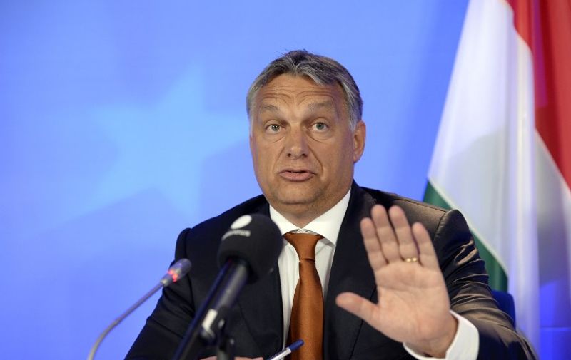Hungary's Prime Minister Viktor Orban gestures as he speaks during a press conference at the European Union (EU) Council building in Brussels, on September 3, 2015. Orban warned on September 3 that the wave of mostly Muslim refugees coming to Europe threatens to undermine the continent's Christian roots -- an idea rejected by German Chancellor Angela Merkel -- and insisted the migrant crisis was a German problem, not a European one as he defended his government's handling of thousands of refugees flooding into his country. AFP PHOTO / THIERRY CHARLIER