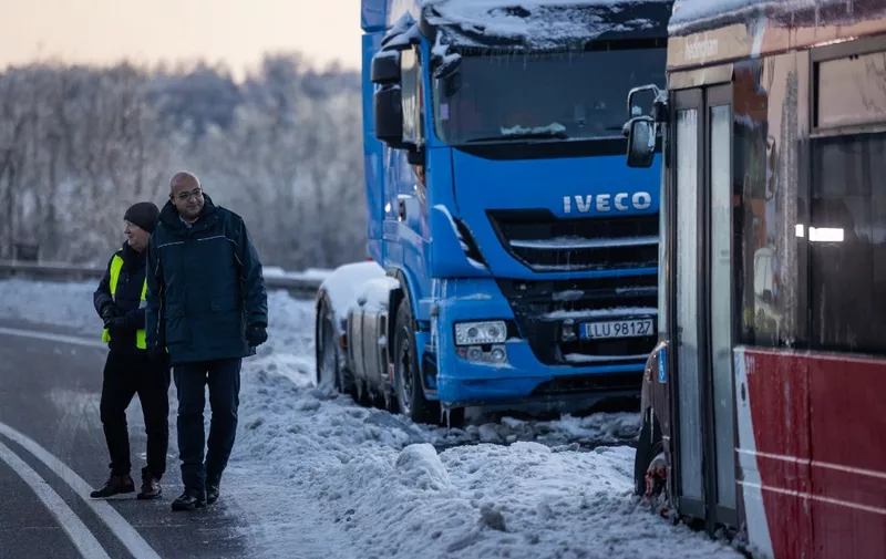 Polish Minister of infrastructure Alvin Gajadhur (R) is seen speaking with truck drivers from different Polish transport company owners blocking the access to Polish-Ukraine border crossing in protest against "unfair" competition in Hrebenne, Poland, on December 4, 2023. (Photo by Wojtek Radwanski / AFP)