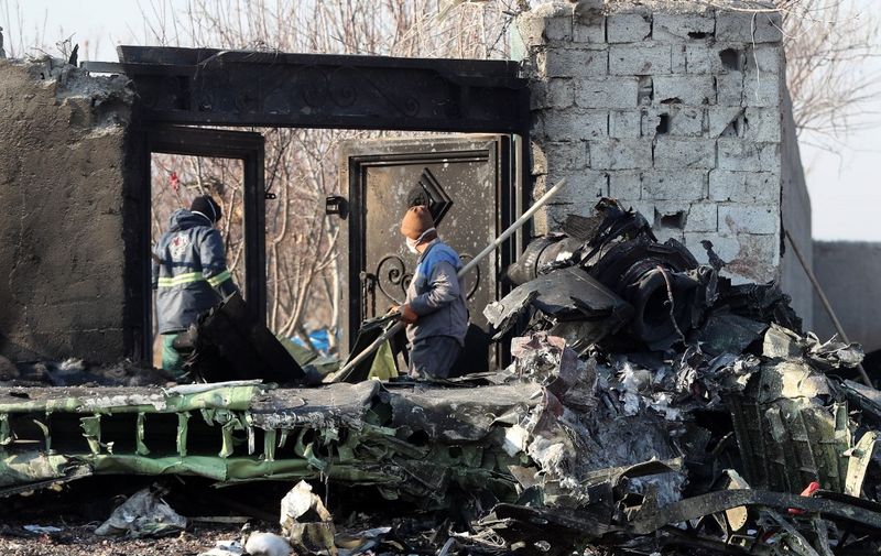EDITORS NOTE: Graphic content / Rescue teams work amidst debris after a Ukrainian plane carrying 176 passengers crashed near Imam Khomeini airport in the Iranian capital Tehran early in the morning on January 8, 2020, killing everyone on board. - The Boeing 737 had left Tehran's international airport bound for Kiev, semi-official news agency ISNA said, adding that 10 ambulances were sent to the crash site. (Photo by - / AFP)