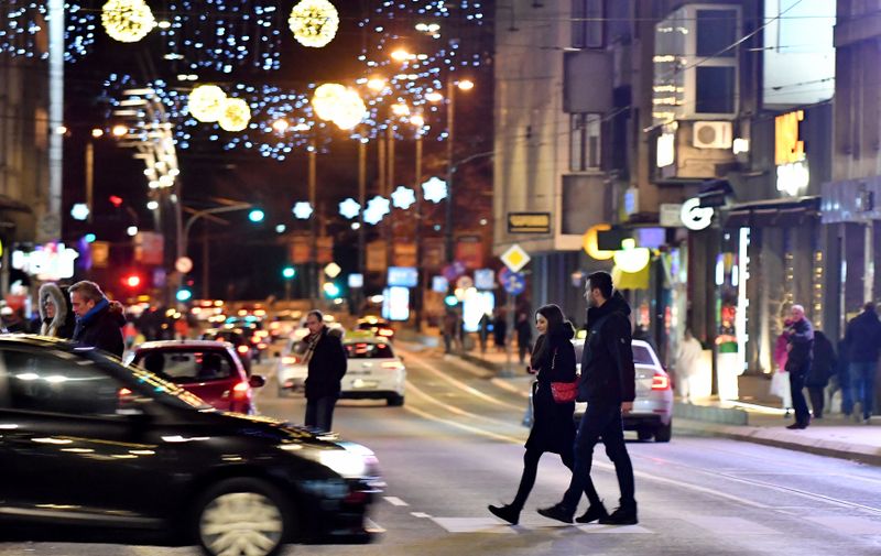 (211225) -- SARAJEVO, Dec. 25, 2021 (Xinhua) -- People walk on a street illuminated with Christmas decorations in Sarajevo, Bosnia and Herzegovina, Dec. 24, 2021.,Image: 649377888, License: Rights-managed, Restrictions: , Model Release: no, Credit line: Profimedia