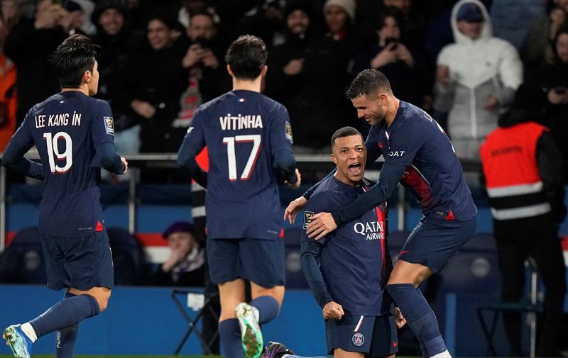 PSG's Kylian Mbappe, center right, celebrates with teammates after scoring his side's second goal, during the French Super Cup final soccer match between Toulouse and Paris Saint-Germain at the Parc des Princes in Paris, Wednesday, Jan. 3, 2024. (AP Photo/Michel Euler)