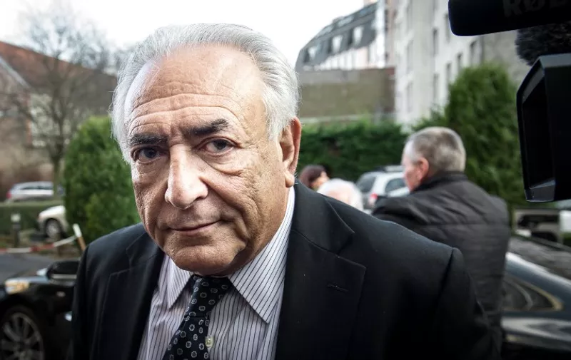 (FILES)- A February 17, 2015 file photo shows former IMF chief Dominique Strauss-Kahn arriving to his hotel in Lille, northern France. A French court in Lille, acquited Dominique Strauss-Kahn of pimping charges in the the so-called "Lille Carlton Hotel Case" trial, on June 12, 2015. AFP PHOTO /  PHILIPPE HUGUEN