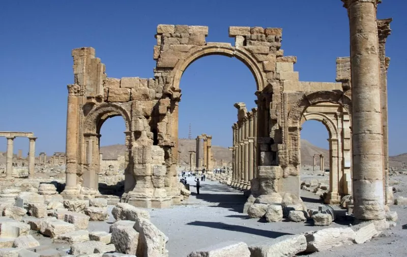 (FILES) A file picture taken on June 19, 2010 shows the Arch of Triumph among the Roman ruins of Palmyra, 220 kms northeast of the Syrian capital Damascus. The Islamic State jihadist group executed three people in Syria's ancient city of Palmyra by binding them to three historic columns and blowing them up, a monitoring group said on October 26, 2015.  AFP PHOTO / FILES