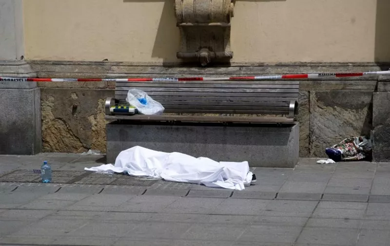 A body is covered on a pedestrian street in Graz, Austria on June 20, 2015 at the scene of an accident. Three people were killed and 34 were injured when a "mentally unbalanced" man drove a 4x4 into a crowded pedestrian street in the southern Austrian city of Graz, a local official said. AFP PHOTO / APA / ELMAR GUBISCH   AUSTRIA OUT