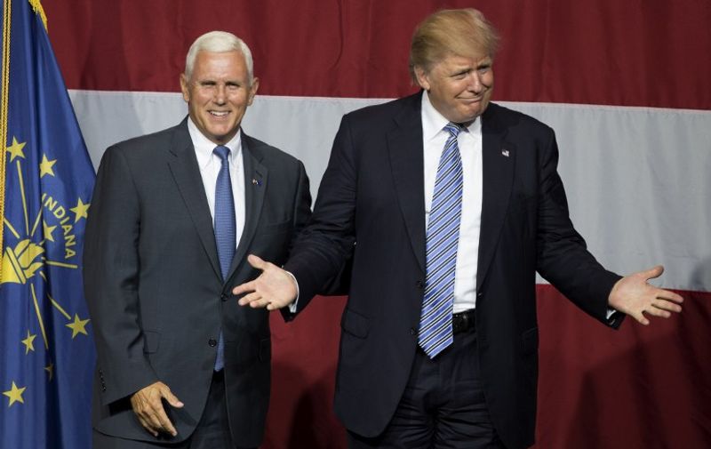 (FILES) This file photo taken on July 12, 2016 shows 
US Republican presidential candidate Donald Trump (R) and Indiana Governor Mike Pence (L) taking the stage during a campaign rally at Grant Park Event Center in Westfield, Indiana.
Trump named Pence as his vice presidential running mate, on July 15, 2016. / AFP PHOTO / Tasos KATOPODIS