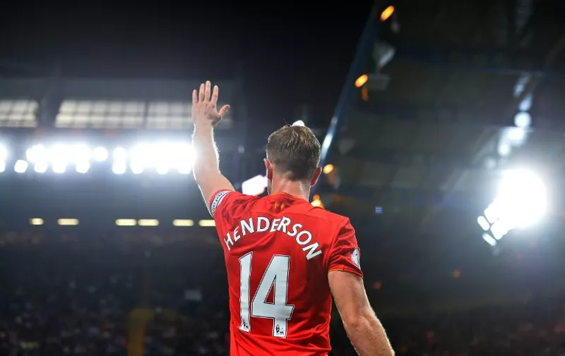 Liverpool's English midfielder Jordan Henderson waves to the fans following the English Premier League football match between Chelsea and Liverpool at Stamford Bridge in London on September 16, 2016.
Liverpool won the match 2-1. / AFP PHOTO / GLYN KIRK / RESTRICTED TO EDITORIAL USE. No use with unauthorized audio, video, data, fixture lists, club/league logos or 'live' services. Online in-match use limited to 75 images, no video emulation. No use in betting, games or single club/league/player publications.  /