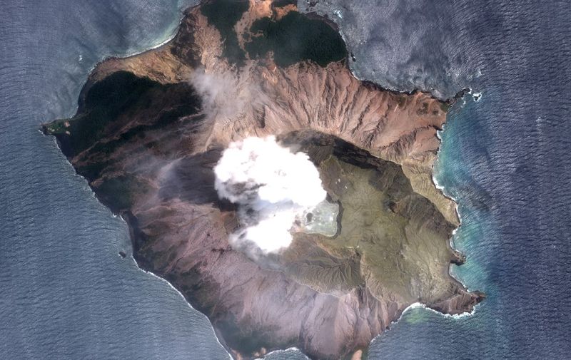 This handout image courtesy of Satellite image ©2019 Maxar Technologies, shows the White Island volcano in New Zealand on the morning of December 11, 2019. - The smouldering New Zealand volcano that killed at least six people is still too dangerous for emergency teams to recover bodies from, police said Wednesday, warning that many tourists who escaped the island were so badly burned they were not yet out of danger. (Photo by HO / Satellite image ©2019 Maxar Technologies / AFP) / XGTY / RESTRICTED TO EDITORIAL USE - MANDATORY CREDIT "AFP PHOTO / SATELLITE IMAGE ©2019 MAXAR TECHNOLOGIES" - NO MARKETING NO ADVERTISING CAMPAIGNS - DISTRIBUTED AS A SERVICE TO CLIENTS --- The watermark may not be removed/cropped
