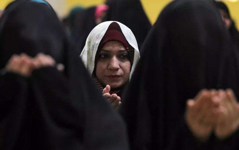 Iraqi Shiite women perform Eid al-Adha prayers at the headquarters of the Shiite Muslim Supreme Iraqi Islamic Council (SIIC) in Baghdad, on September 24, 2015. Eid al-Adha (the Festival of Sacrifice) is celebrated throughout the Muslim world as a commemoration of Abraham's willingness to sacrifice his son for God, and cows, camels, goats and sheep are traditionally slaughtered on the holiest day.  AFP PHOTO/ AHMAD AL-RUBAYE