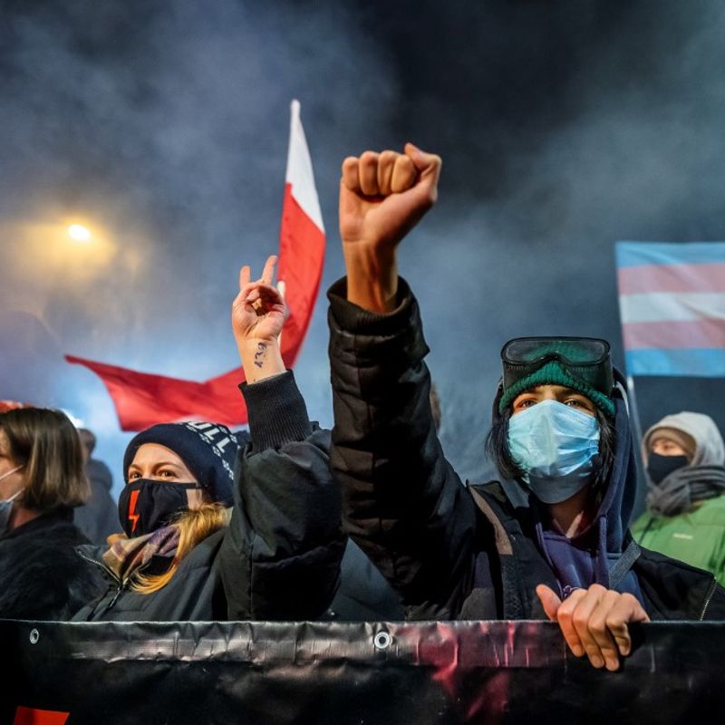 A demonstrator gestures as people take part in a pro-choice protest in the center of Warsaw, on January 27, 2021, as part of a nationwide wave of protests since October 22, 2020 against Poland's near-total ban on abortion. - A demonstrator holds a banner reading "Abortion on demand" as she takes part in a pro-choice protest in the center of Warsaw, on January 27, 2021, as part of a nationwide wave of protests since October 22, 2020 against Poland's near-total ban on abortion. A controversial Polish court ruling that imposes a near-total ban on abortion will come into force on January 27, 2021, the country's right-wing government said, in an announcement that triggered protests. (Photo by Wojtek RADWANSKI / AFP)