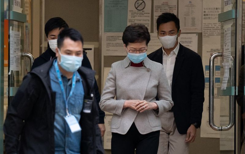 Hong Kong Chief Executive Carrie Lam leaves a polling station after casting her vote in the Legislative Council election in Hong Kong on December 19, 2021. (Photo by Bertha WANG / AFP)