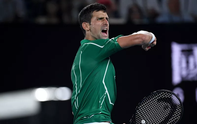MELBOURNE, AUSTRALIA - JANUARY 30: Novak Djokovic of Serbia celebrates after winning set point during his Men's Singles Semifinal match against Roger Federer of Switzerland on day eleven of the 2020 Australian Open at Melbourne Park on January 30, 2020 in Melbourne, Australia. (Photo by Hannah Peters/Getty Images)