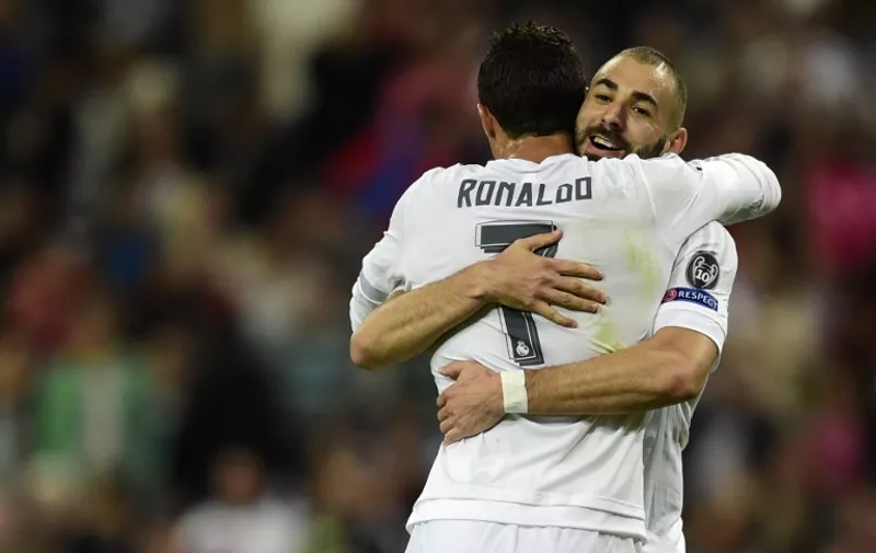 Real Madrid's French forward Karim Benzema (R) celebrates a goal with Real Madrid's Portuguese forward Cristiano Ronaldo during the UEFA Champions League group A football match Real Madrid CF vs FC Shakhtar Donetsk at the Santiago Bernabeu stadium in Madrid on September 15, 2015. AFP PHOTO/ JAVIER SORIANO